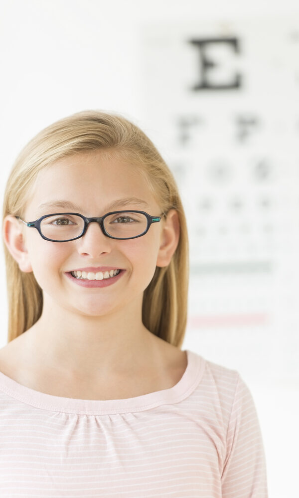 Confident Girl Wearing Glasses Against Eye Chart