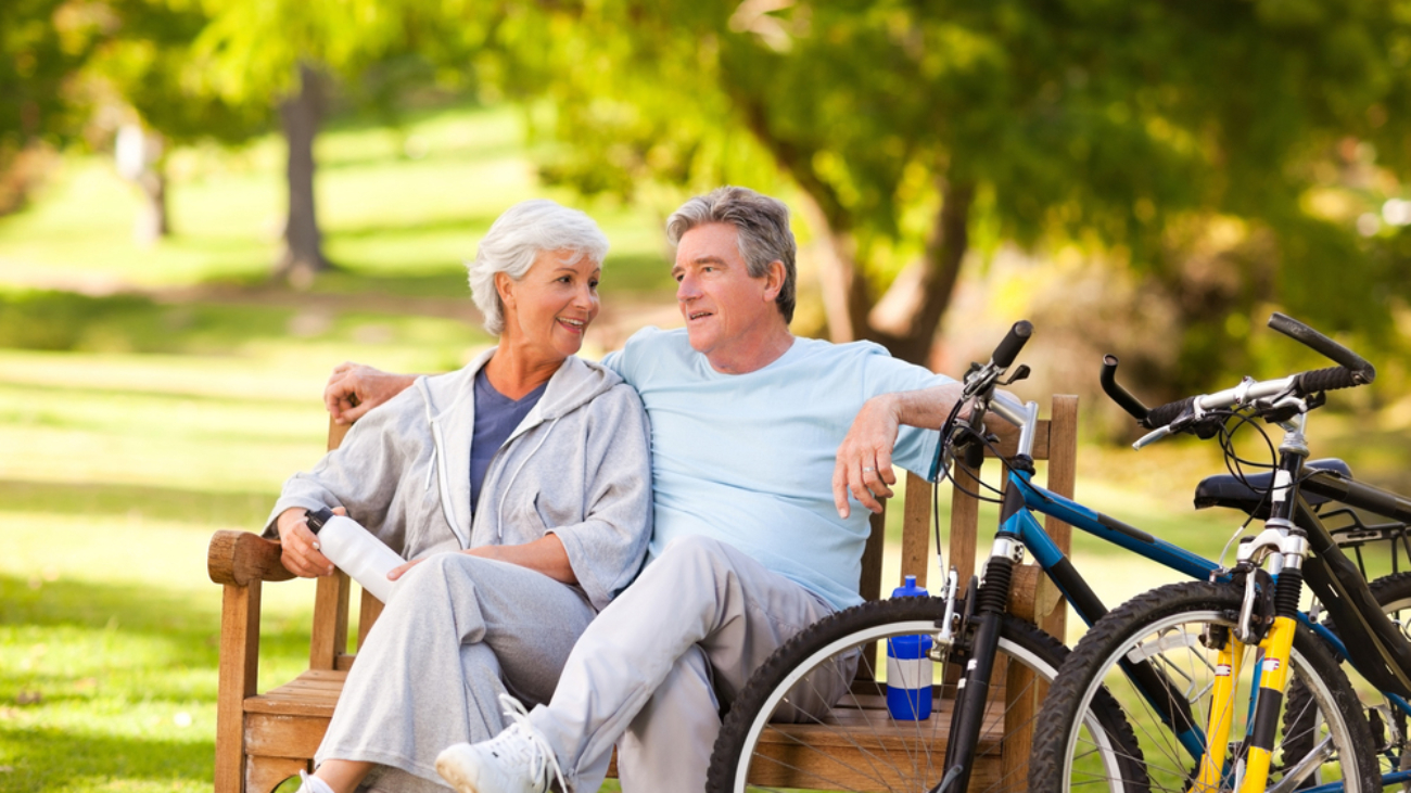 Elderly couple in park after a bike ride -Take Charge of Your Health
