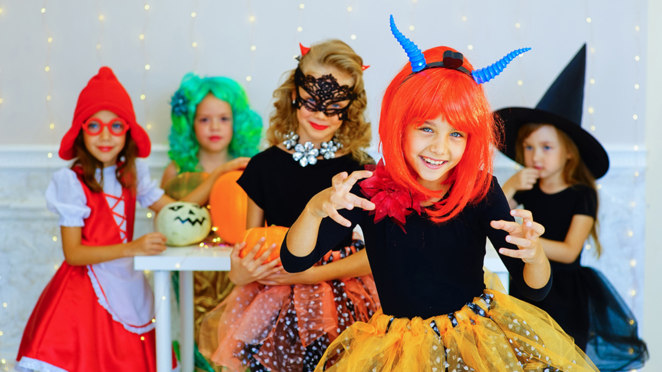 Happy group of children in costumes during Halloween party - eye safety for kids