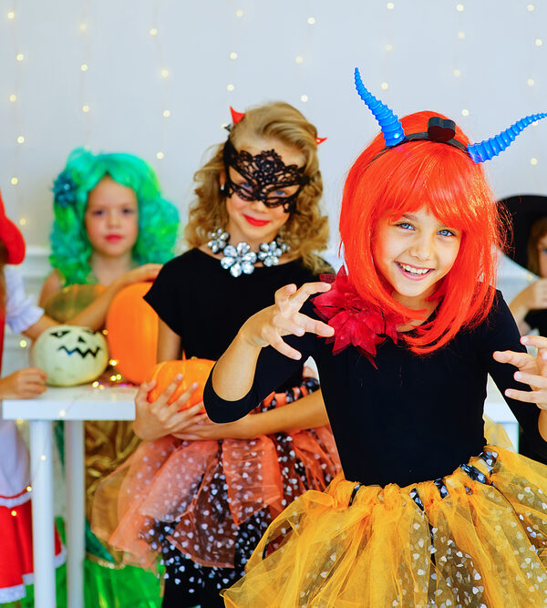 Happy group of children in costumes during Halloween party - eye safety for kids