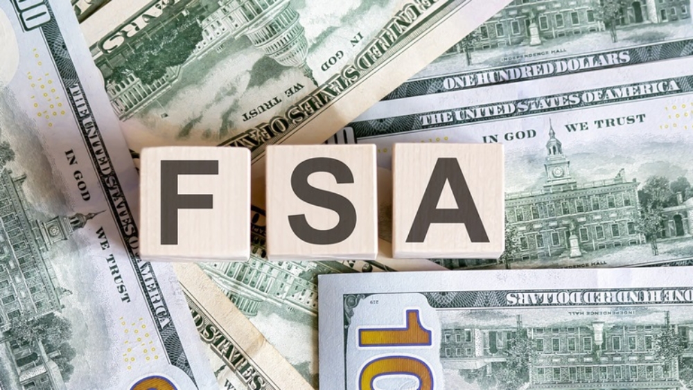 Concept-words-FSA-adjustments-on-wooden-blocks-on-beautiful-background-from-dollar-bills.