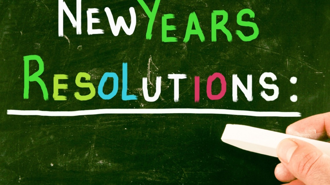 The-words-New-Years-Resolutions-written-in-different-colors-on-chalkboard