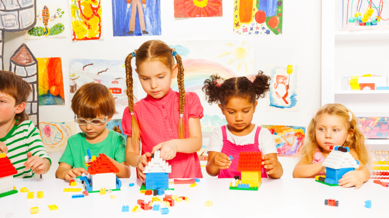 Child’s Eye Exams group of young children playing with colorful blocks on white table