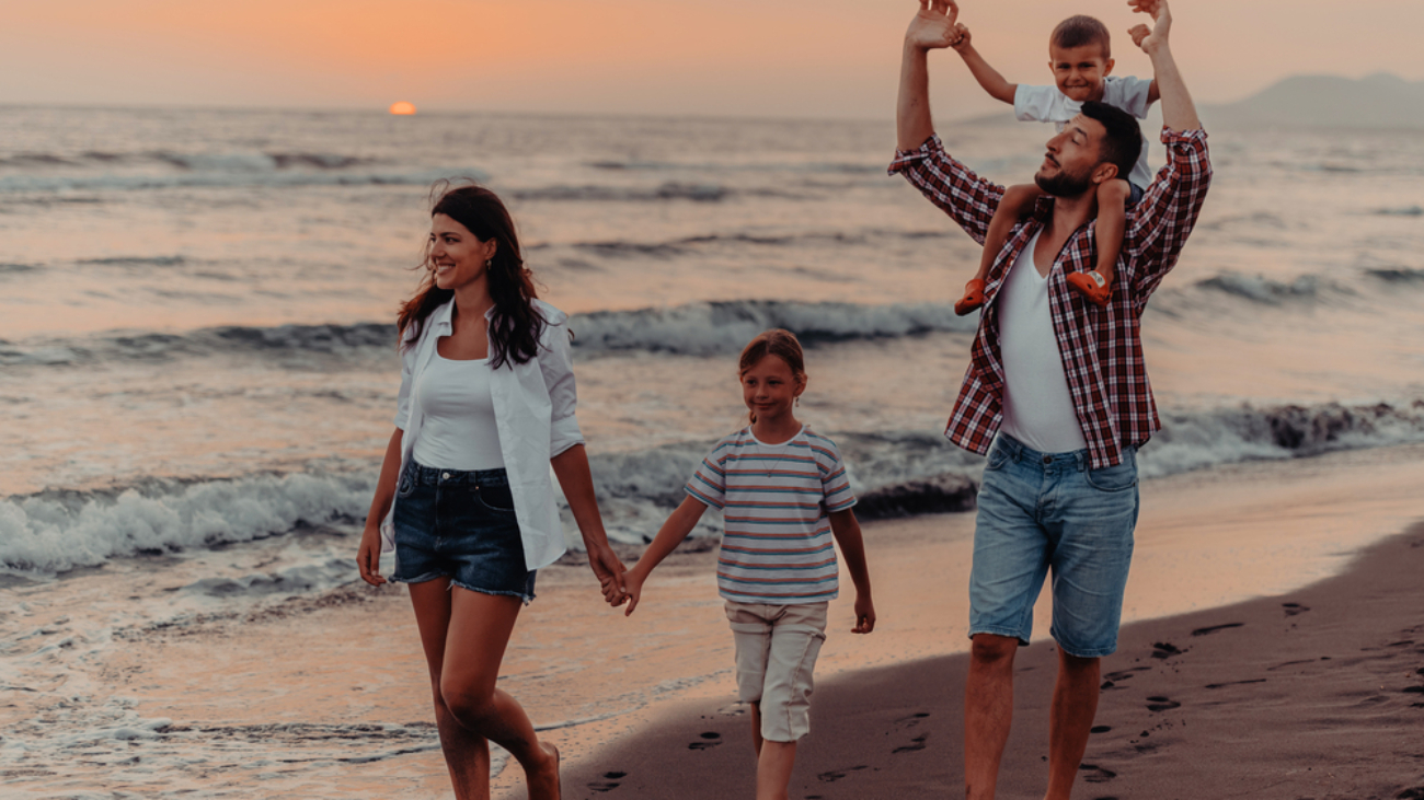 Family gatherings and socializing on the beach at sunset. The family walks along the sandy beach. Contact Lens safety near water
