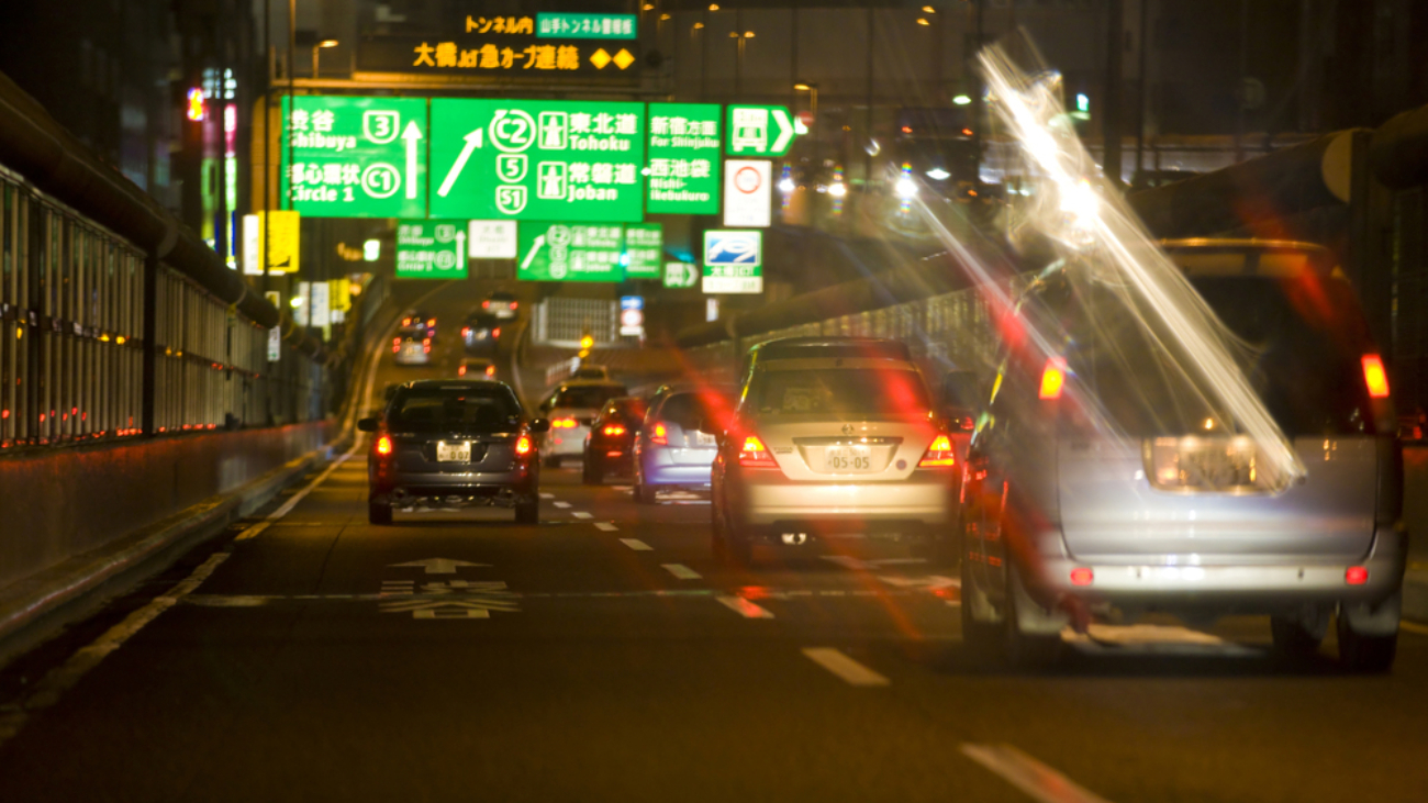 night time traffic on a highway with blurred tail gate lights from poor vision - safe night driving