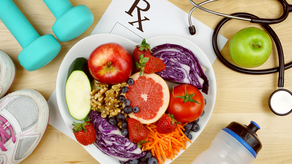 heart shaped bowl full of fruits and veggies representing heart health and your eyes