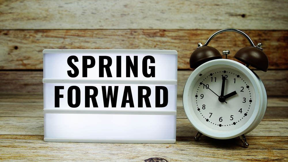 sign with the text spring forward by a clock on a wooden background reprensing vision and sleep