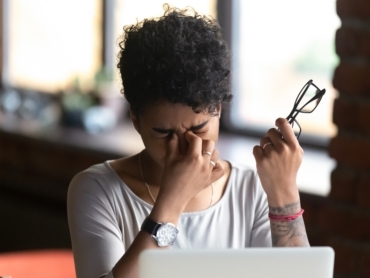 African American woman taking off glasses, feel eye strain, massaging nose bridge, tired female feeling discomfort after long wearing glasses at workplace, work with computer, bad eye vision close up