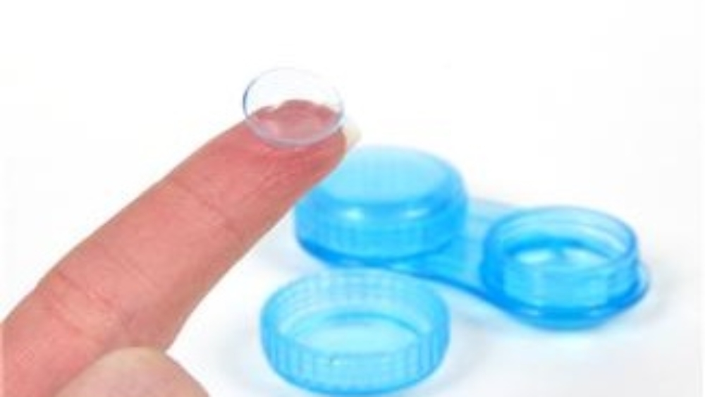 contact lens case with contact lens on finger