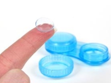 contact lens case with contact lens on finger