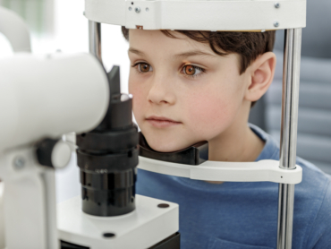 Child having test of his eyesight for a back-to-school eye exam
